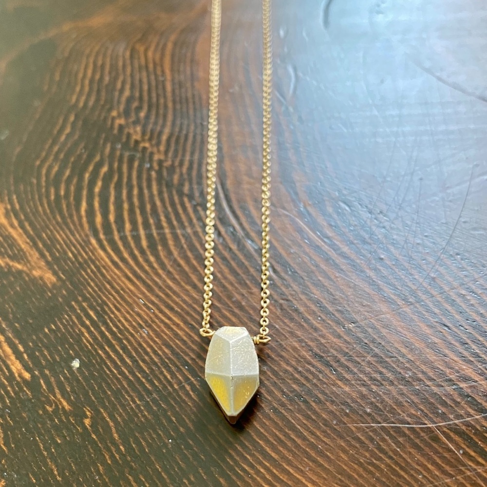 Delicate gold necklace with prism cut pendant